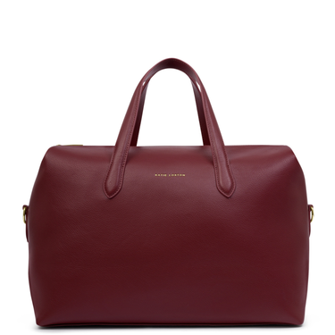 Maroon handbag with gold hardware on a white background