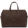 A dark brown leopard-print duffle bag with two top handles, gold-tone hardware, and a small gold  logo plaque on the front, shown against a plain white background.