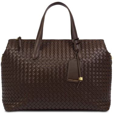 A dark brown woven leather handbag with double top handles, a hanging leather tag, and gold-tone hardware, photographed on a clean white background.