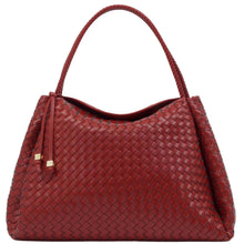 A red woven leather handbag with a single top handle and a small leather tassel detail, shown against a plain white background.