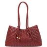 A woven leather tote bag in a deep burgundy red, featuring two braided shoulder straps and small gold-tone hardware accents, set against a plain white background.