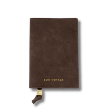 Brown suede passport holder with 'Bon Voyage' text on a white background