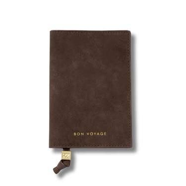 Brown suede passport holder with 'Bon Voyage' text on a white background