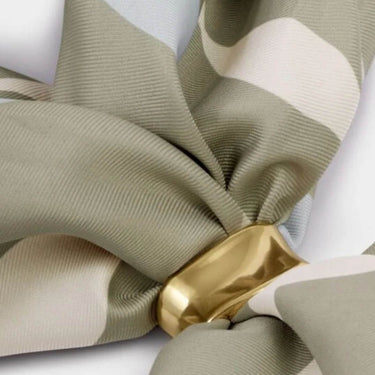 Close-up of a gold ribbon holder on ribbed fabric