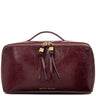 A burgundy leather cosmetic bag by Katie Loxton with gold-tone hardware, a top handle, and two leather tassel pulls on the zipper, shown against a plain white background.