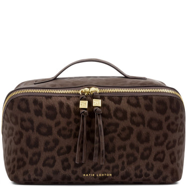 A Katie Loxton brown leopard print cosmetic bag with a top handle, gold zippers, and tassel pulls on a white background.