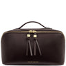 A dark brown pebbled leather cosmetic bag by Katie Loxton, featuring a top handle, gold-tone zippers with leather tassel pulls, and gold brand lettering on the front.