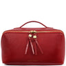 A red leather cosmetic bag by Katie Loxton with a top handle, gold zipper, and matching leather tassel zipper pulls on a white background.