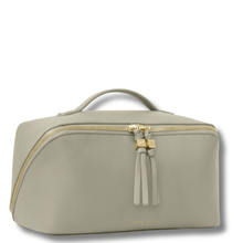 Light gray toiletry bag with gold zipper and tassel on a white background