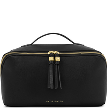 Black leather bag with gold zipper and tassels on a white background
