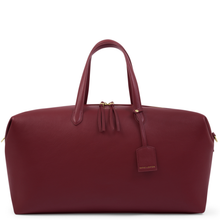 Maroon leather bag with gold accents on a white background