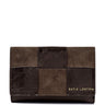 A Katie Loxton patchwork wallet in dark brown and medium brown textured leather, featuring gold lettering on the bottom right, set against a plain white background.