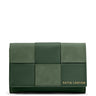 A green Katie Loxton wallet with a woven-look patchwork design and gold brand lettering on the bottom right, set against a plain white background.