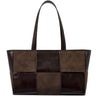 A patchwork leather tote bag by Kate Cotton in shades of brown, featuring a mix of smooth leather and suede-like panels, dual shoulder straps, and a small gold brand logo on the bottom right corner.