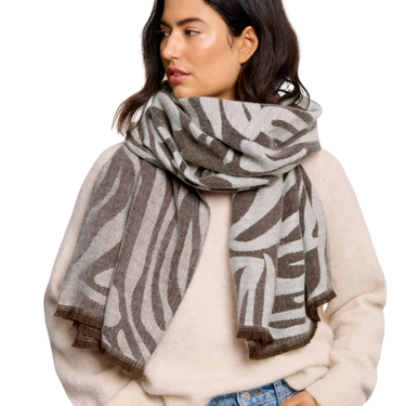 Woman wearing a patterned scarf on a white background