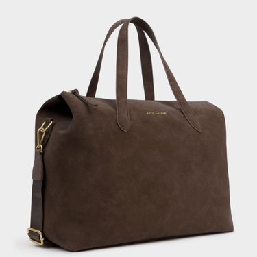 Brown leather bag with gold zipper on a light gray background