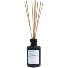 A reed diffuser bottle in matte black with natural wood reeds, featuring a white label with green and black text that reads 'LA BOUGIE LICHEN & WINTER JASMINE'.