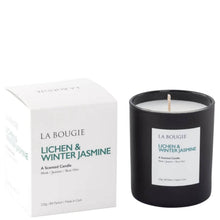 La Bougie Lichen & Winter Jasmine scented candle shown with its white product box and a matte black glass jar candle on a clean white background.