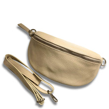 Beige leather waist bag with a strap on a white background
