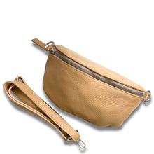 Beige leather waist bag with a strap on a white background