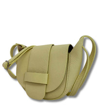 Green leather saddle bag on a white background