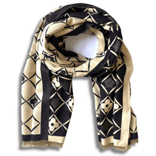 Black and beige patterned scarf on a white background