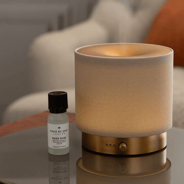 Textured lamp with a bottle of essential oil on a reflective surface