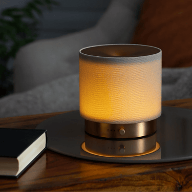Textured table lamp on a wooden surface with a blurred background