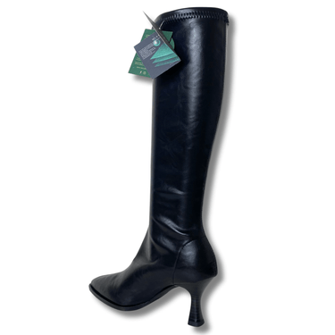 Black knee-high boot with a heel on a white background