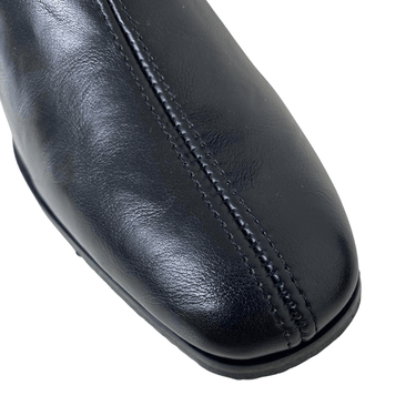 Close-up of a black leather shoe sole on a white background