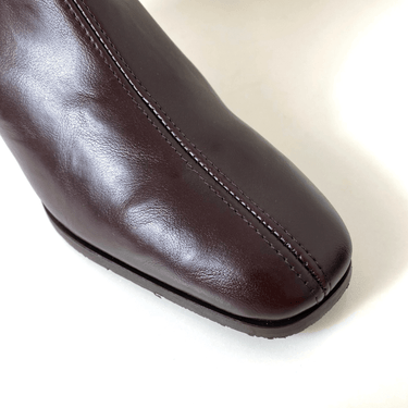 Close-up of a brown leather shoe on a white background