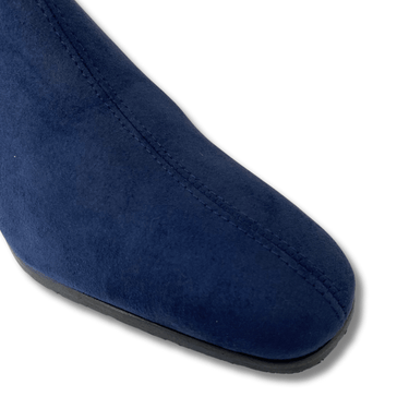 Close-up of a blue suede shoe on a white background