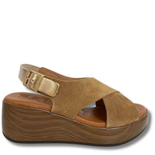 Brown wedge sandal with a gold buckle on a white background