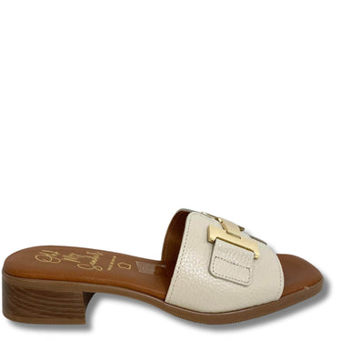 Beige sandal with gold buckle on a white background