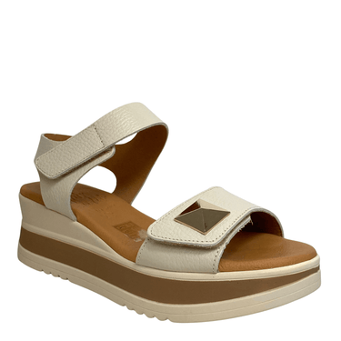 Beige sandal with brown sole on a white background