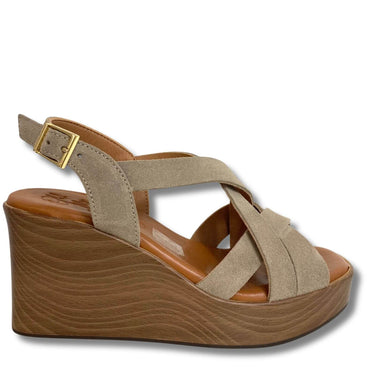 Beige wedge sandal with a brown sole on a white background