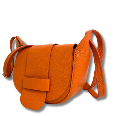 Orange leather handbag with a strap on a white background