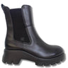 A black leather Chelsea-style ankle boot with a chunky lug sole and a black elastic side gore featuring a small monogram logo.