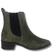 An olive green suede Chelsea boot with a black elastic side panel and a low dark brown block heel, shown from a side profile on a white background.