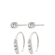 Silver hoop earrings with embedded crystals on a white background