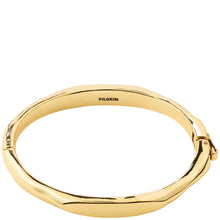 A gold-plated hinged bangle bracelet with a polished, slightly textured outer surface. The brand name 'PILGRIM' is engraved inside the band.