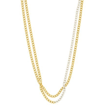 Two layered Cuban link chains, one in yellow gold and one in silver, shown against a plain white background.