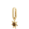 Gold sun-shaped pendant with a brown gemstone on a white background