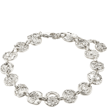Silver bracelet with floral designs on a white background