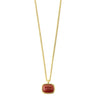 A gold chain necklace with a rounded rectangular red gemstone pendant, shown against a plain white background.