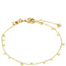 A delicate gold chain anklet featuring small flat round disc charms and a lobster clasp closure, displayed on a clean white background.
