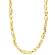 A gold-colored beaded necklace with irregular, polished disc-like beads, shown against a plain white background.