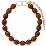 A beaded bracelet made of glossy, polished brown glass beads with a gold-tone clasp featuring interlocking oval links and an extender chain, shown on a plain white background.