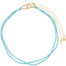 Turquoise beaded necklace with gold chain on a white background
