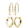 A set of gold-toned earrings on a plain white background, including two fishhook drop earrings with small clear stones and white pearl beads, and two abstract textured hoop earrings.
